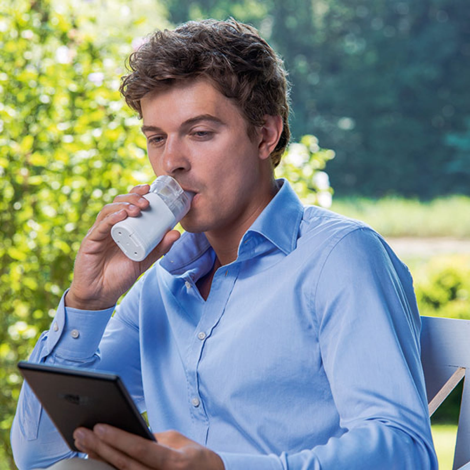 Adult using the silent OMRON MicroAir U100 nebuliser