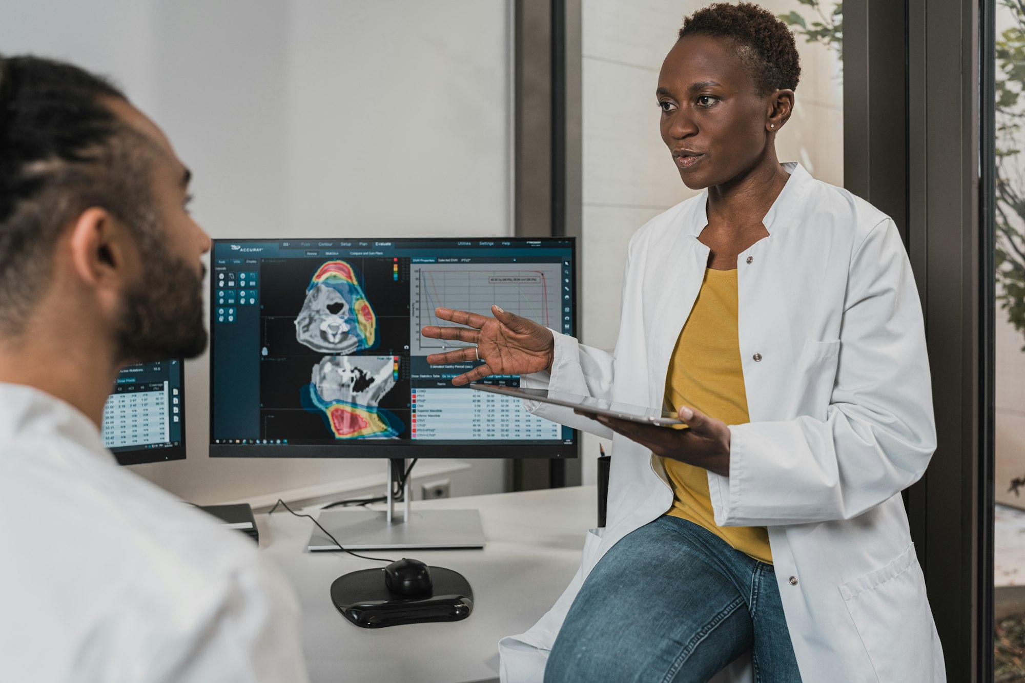 Radiologists reviewing a CT study on a workstation screen
