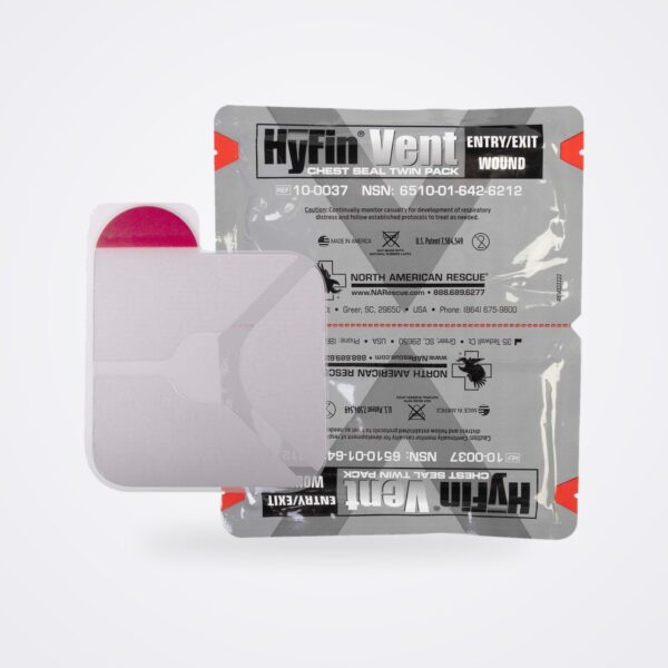 HyFin Vent chest seal with red pull tab shown in front of its grey twin foil pouch