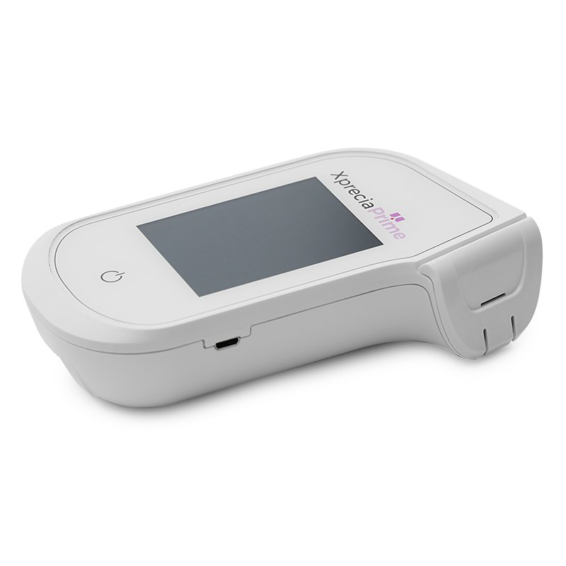 جهاز تحليل التخثر Xprecia Prime من Universal Biosensors لقياس زمن البروثرومبين/النسبة المعيارية الدولية (PT/INR) 3 جهاز Xprecia Prime من الجانب يظهر فيه منفذ شريط الاختبار وشاشة اللمس